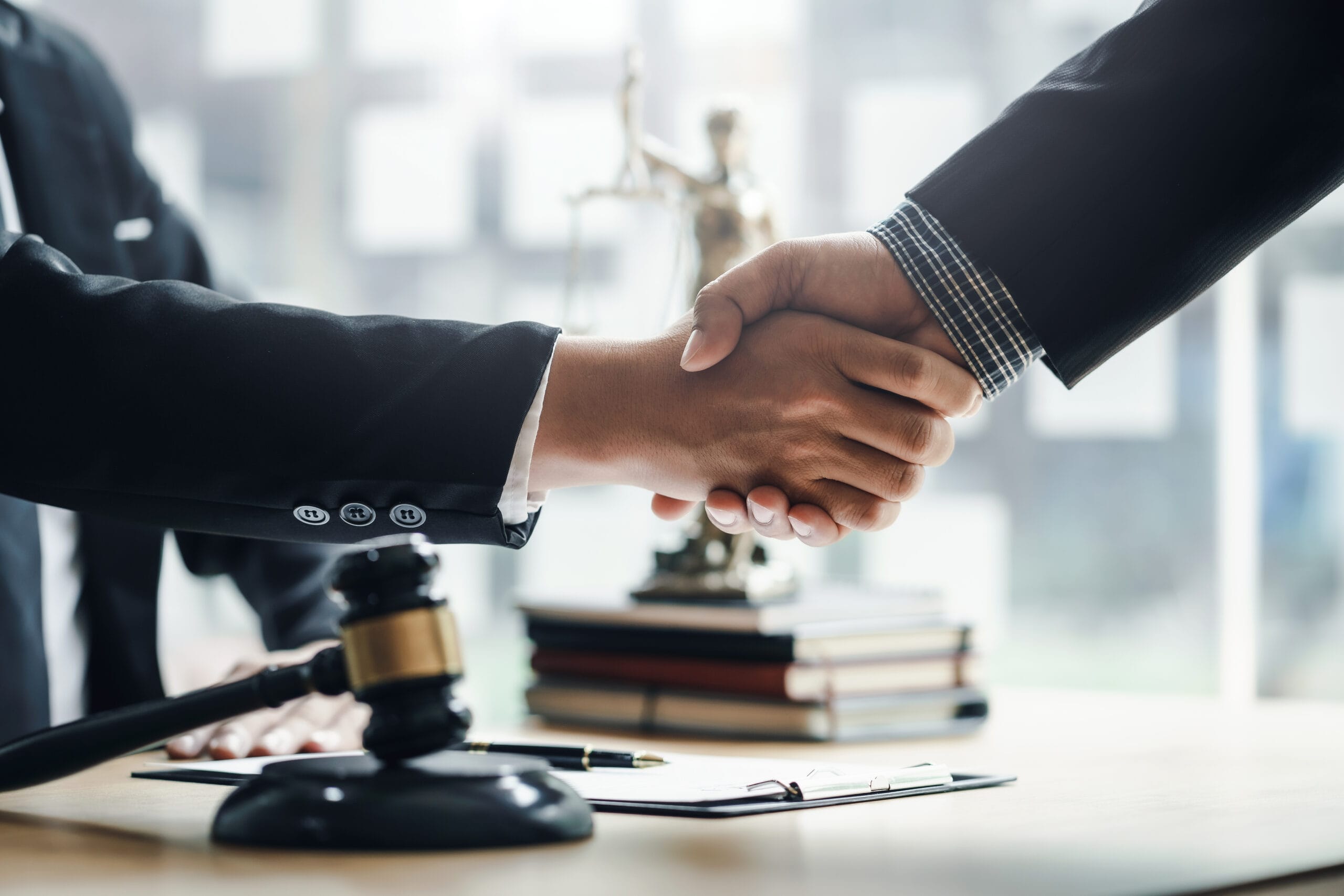 handshake lawyer and client over a contract