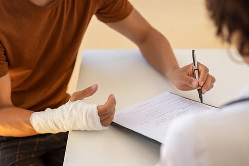 an injured man filling out a form